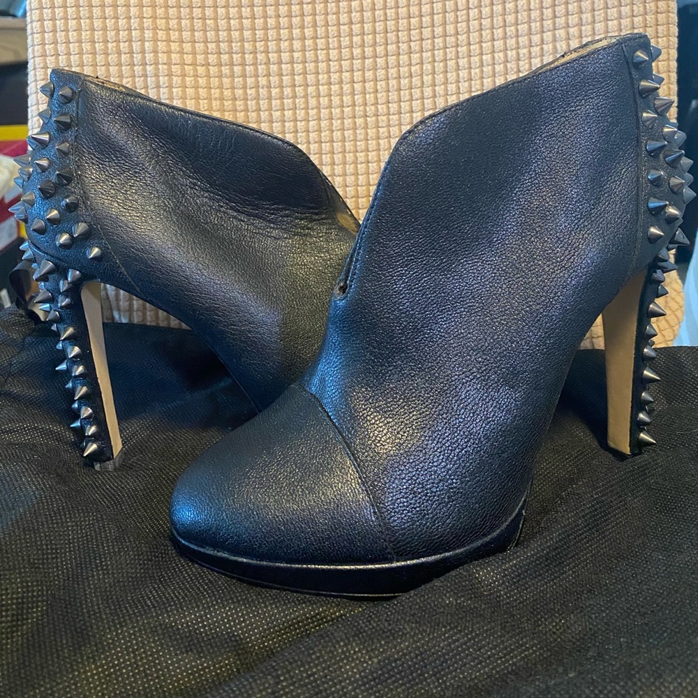 BCBG MaxAzria black ankle boots heel with slit in the front. Genuine leather